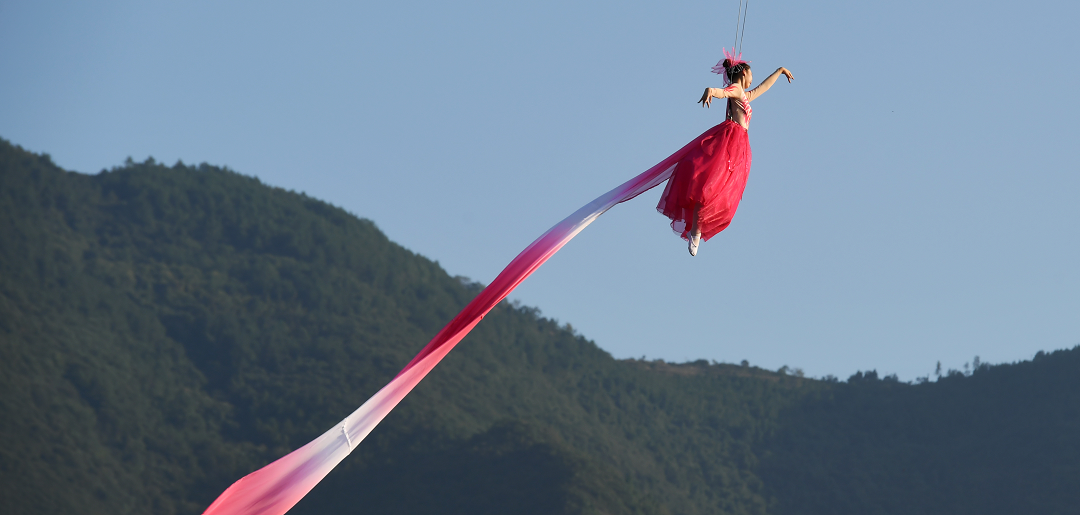 演员身着红衣空中起舞，在画诗环节献上一曲《桃花》